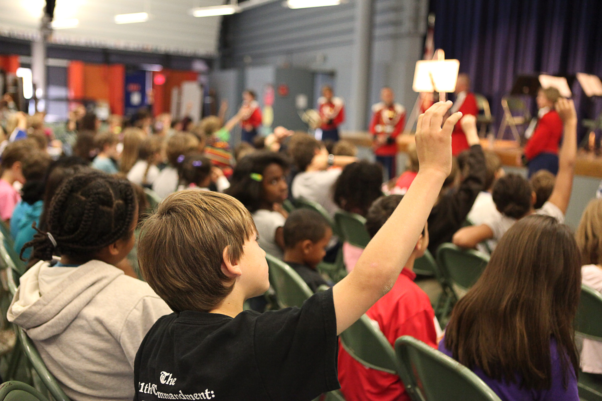 children raising their hands